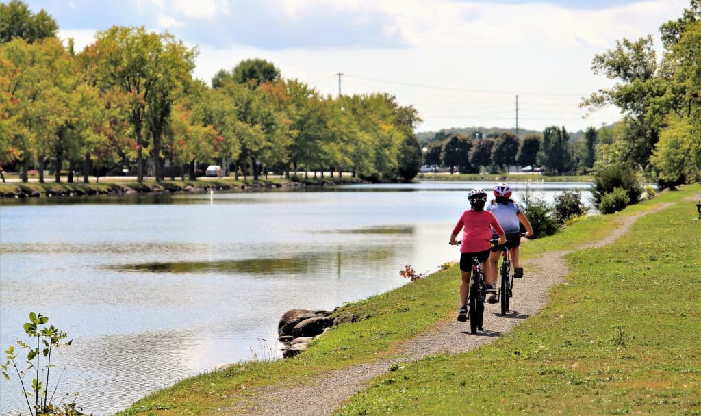Girls cycling along the Rotary Trail along the Trent Severn Waterway in Campbellford Trent Hills Ontario