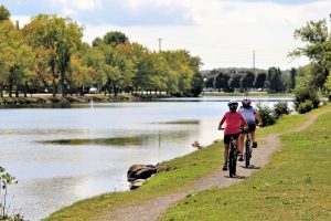 Girls cycling along the Rotary Trail along the Trent Severn Waterway in Campbellford Trent Hills Ontario